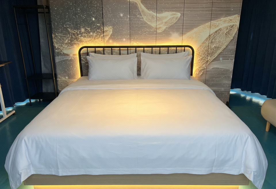 Illuminated whale art headboard in the king dome room Turtle Garden Resort